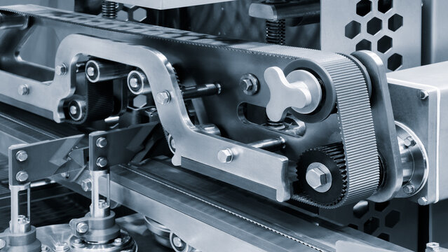 A close-up of a conveyor for packaging pharmaceuticals and tablets. The conveyor is modern and clean. Pharmaceutical concept.