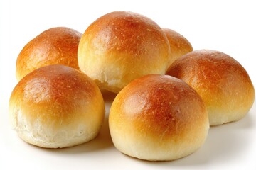 Golden baked bread rolls on white surface for culinary and food concepts