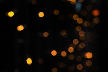 Obraz premium Warm orange bokeh lights creating sparkling and magical holiday atmosphere