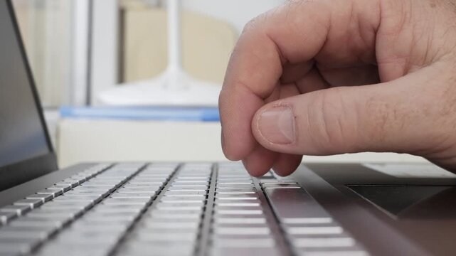 Hand Typing on Laptop Keyboard Closeup Detail