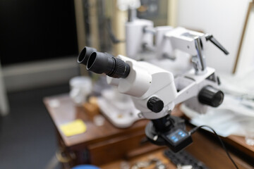 Fototapeta premium Stereo microscope on workbench magnifying details for precision work