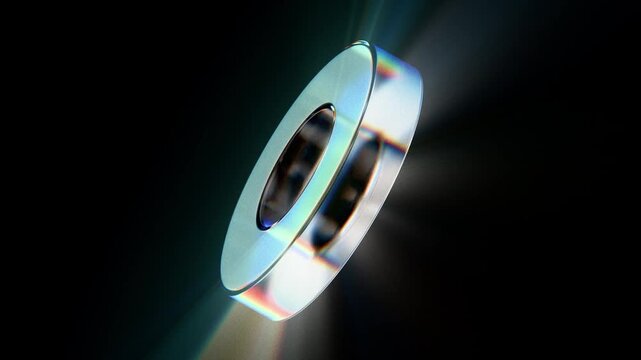 Looped dynamic animation of a torus shape made of liquid glass material. Animation with rays of light refraction with the effect of gradient color transition. Animation of a glass shape with the effec