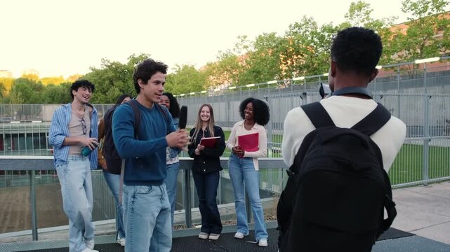 Group of diverse university students making a video together on campus after class
