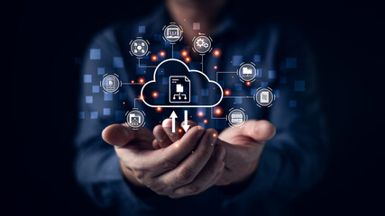 Fototapeta premium Businessman hands holding virtual cloud computing icon with download and upload data transfer. Internet network technology concept for online storage system and digital file backup service.