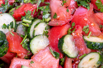 Mediterranean inspired tomato cucumber herb salad using sunflower oil alternative, chopped mint and parsley, zesty lemon notes, fresh garden produce, colorful plated side