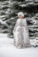 The Snow Queen. Fashion portrait of a beautiful young girl in a winter national russian costume