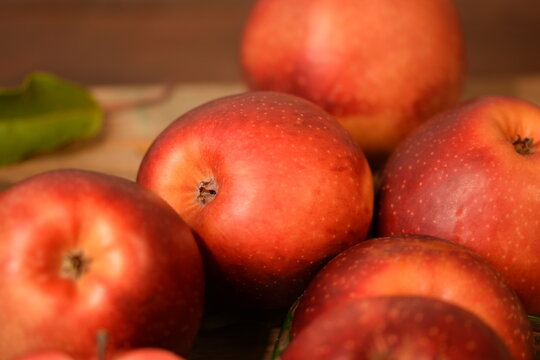 Baya Marisa apples on wooden background, red pulp and skin apples closeup.