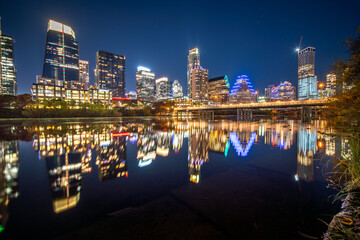 Fototapeta premium Austin Downtown modern office hub of world technology center business urban city landscape of skyscraper and travel destination park along the river and park in capital city of Texas, USA at sunset