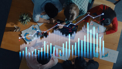 A diverse team collaborates in an office environment surrounded by charts and graphs, analyzing data trends for informed strategic decision-making. Scalp
