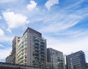 Obraz premium Residential buildings in the Buenos Aires district during the day against a blue sky with clouds
