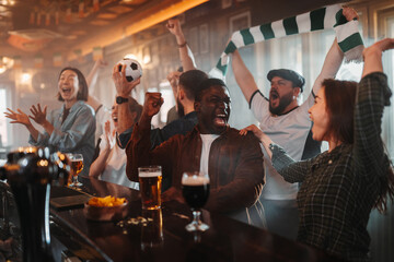 Diverse group of friends cheering at soccer match in bar © Zamrznuti tonovi