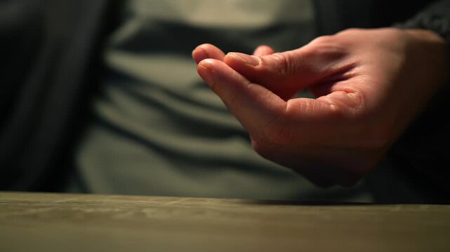 A dirty table surface.
A man runs his index finger across a dusty table in a room.