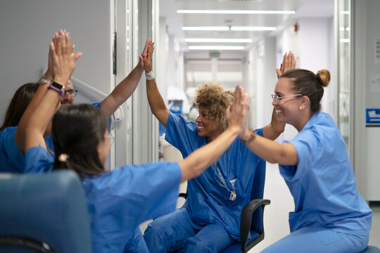 Medical team giving high five celebrating achievement