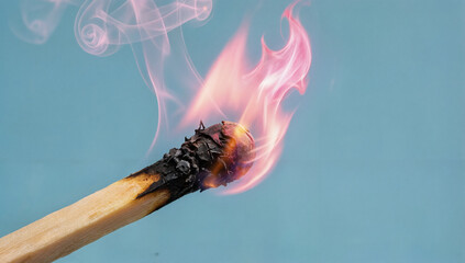 Burning match with rising smoke and a pink flame, ignition and new ideas concept