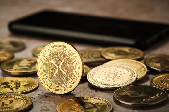 Xrp cryptocurrency coin on a table with other digital currency representations