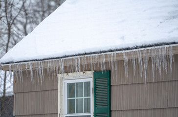 Fototapeta premium winter house with icicle and snow on the roof