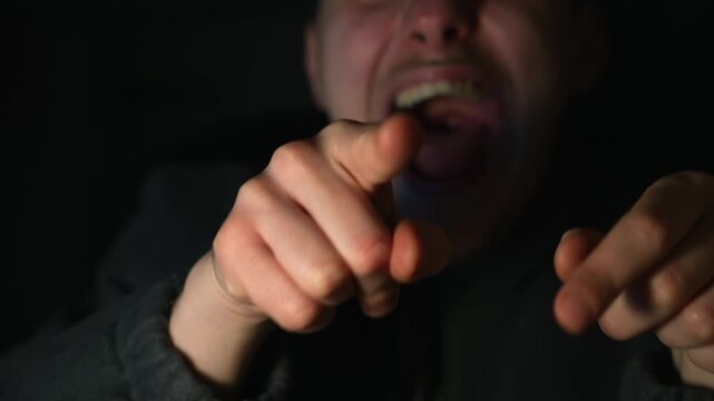 Bullying in the family.
A man accuses someone and points his fingers at him with an angry expression.
A rude person points with his index finger.