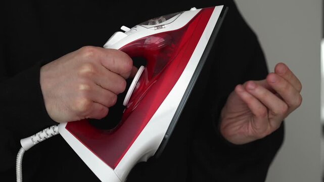 Burned hand.
Burn pain.
A man touches a hot iron and gets a severe burn on his finger.