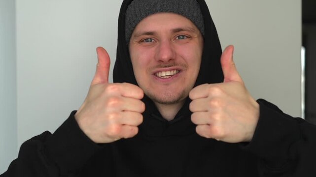 A smiling man gives a thumbs-up.
The man approves and likes.
A close-up of a thumbs-up.