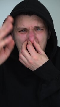 Gas leak and unpleasant odor.
Unpleasant odor.
A man tries not to breathe in the noxious gas and fumes.