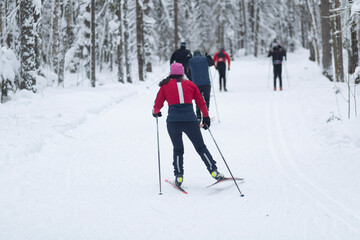 Cross-country skiing in hilly terrain in winter. Outdoor fitness.