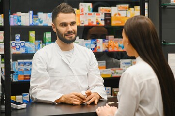 Pharmacist advising customer about medicine in drugstore