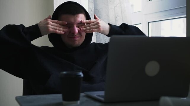 A man working at a computer rubs his eyes due to fatigue.
Dryness of the mucous membrane of the eyes.
Vision problems.