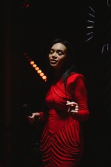 Female singer performing live in red dress