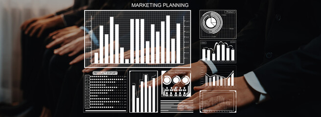 A group of business professionals actively participating in a marketing planning session, featuring digital graphs and charts that illustrate key data analysis and strategies for growth. Axiom