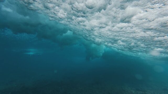 Surfer rides the wave in the Maldives and falls