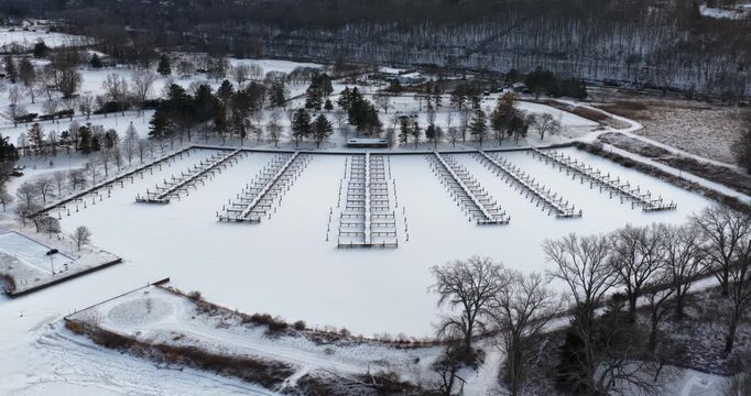 Ithaca, NY, USA. 01-24-2026  Winter aerial video of frozen, snowy marina, docks at Allan H Treman State Marine Park,