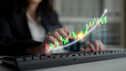 A business analyst interacts with stock market data on a computer keyboard. Digital graphs and charts illustrate trends and financial performance, capturing the essence of modern finance. Impute