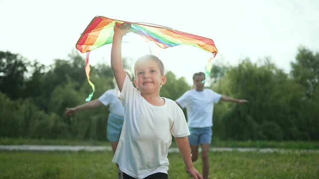 Happy children run in field. Group kids fly colorful kite. Children enjoy summer fun outdoors. Happy children play in nature. Kids run and fly kite. Childhood joy field. Children experience happiness.