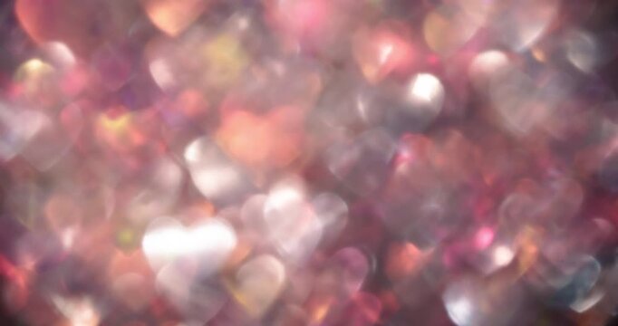 Large soft-focus heart bokeh in warm pastel tones with subtle rainbow highlights. Dreamy stop-motion style abstract background for romance, celebrations, and seamless looping overlays.