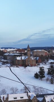 Ithaca, NY, USA - January 24, 2026 Vertical winter aerial video of Cornell University, Ithaca, NY with snow on the ground.
