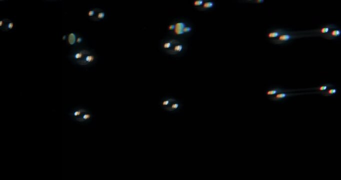 This captivating video showcases delicate soap bubbles floating against a black background, perfect for innovative motion graphics and exceptional visual effects that captivate viewers
