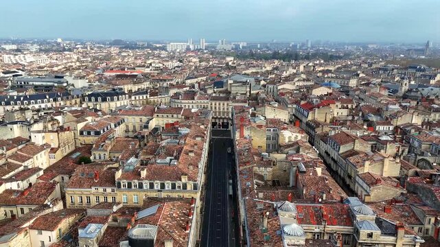 High aerial drone view of Bordeaux avenue and old town rooftops