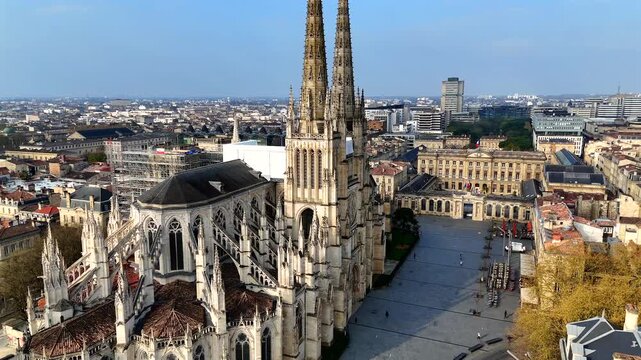 Cinematic aerial of Bordeaux basilica rising above historic city center