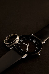 Closeup of Beautiful Classic Black Wristwatch and Diamond Ring