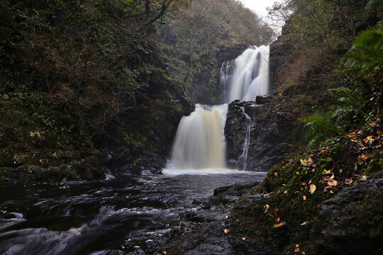 Rha Waterfall (Falls of Rha), Isle of Skye; double cascade on the wooded River Rha in Uig Glen, lush nature reserve setting near Uig Bay, scenic Scottish Highlands waterfall, Scotland, UK