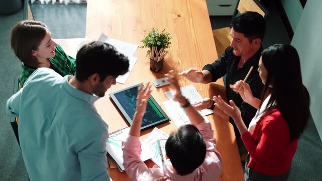 Top view of happy creative team putting hands together while drawing mind map. Group of diverse people working together brainstorming marketing idea and sharing plan by using sticky notes. Convocation
