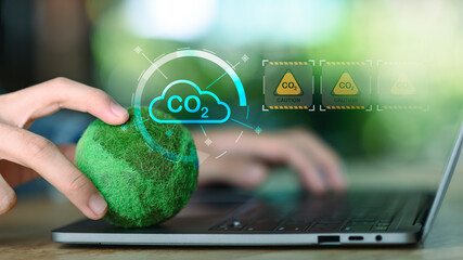 Carbon emission monitoring concept with CO2 cloud interface, green technology, digital analytics on laptop devices, representing climate control, environmental data tracking, sustainable innovation.