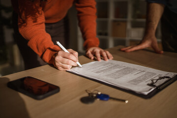Person signing legal contract for real estate deal