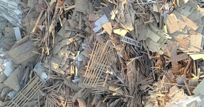 A pile of wood and debris with a lot of boards scattered around