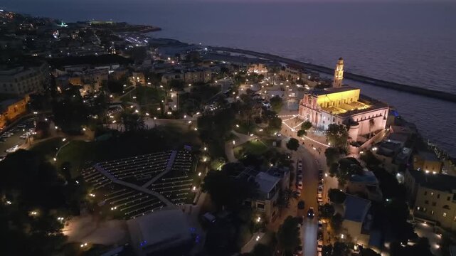 Aerial view of St. Peter's Church and Old Jaffa port at night, Mediterranean coast landscape