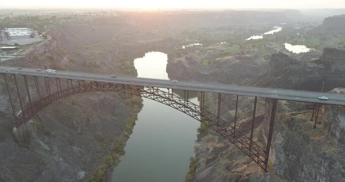 A bridge spans a river with a beautiful view of the surrounding landscape