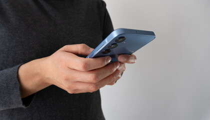 A person is holding a blue cell phone in their hand
