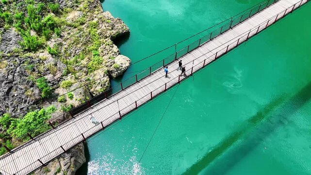 Neighbors on a Bridge: A Few Locals Walking on a Suspension Bridge in Guangxi Countryside