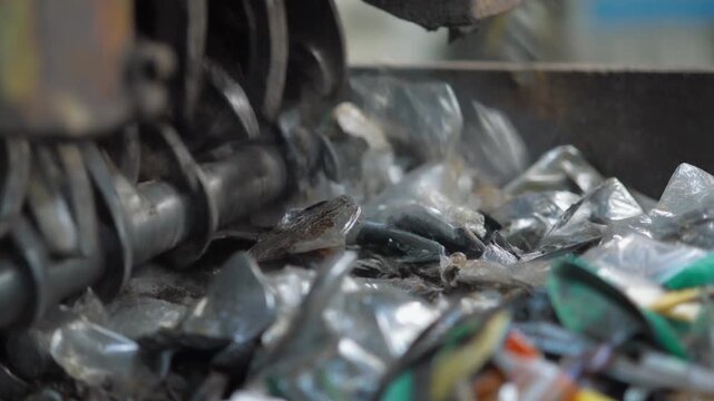 Industrial Shredder Grinding Plastic Bottles for Recycling Process.