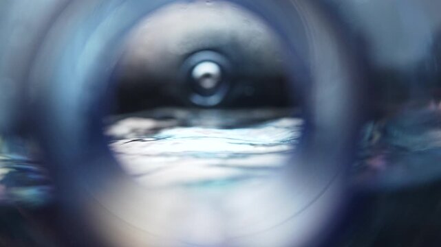 Water jug zoom macro abstract close-up looking inside a plastic water bottle. Flowing water surface, clean hydration concept, purity, freshness and minimal background.